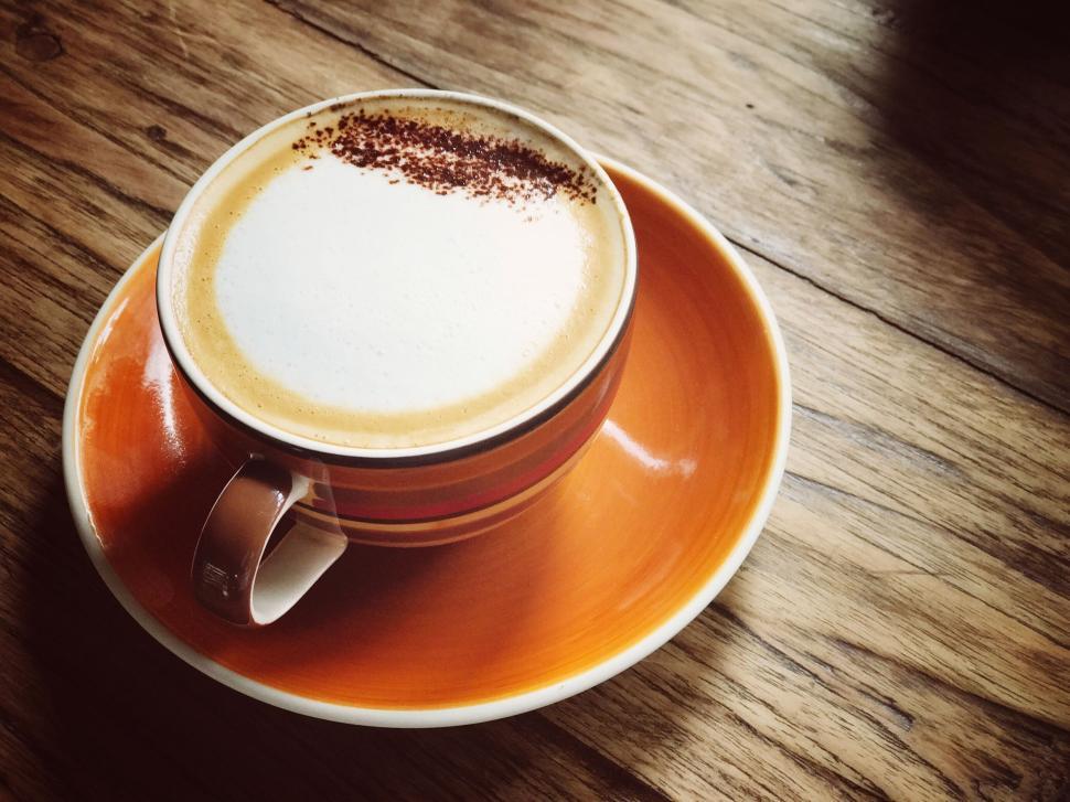 Free Image of A perfectly brewed cappuccino in an orange cup. 