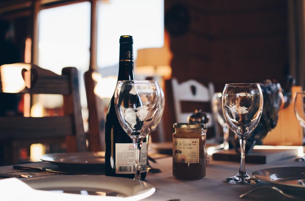 Free Image of Table set with wine bottle, glasses, and condiment jar 