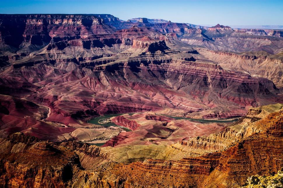 Free Image of Grand Canyon s vast landscape showing cliffs and river. 