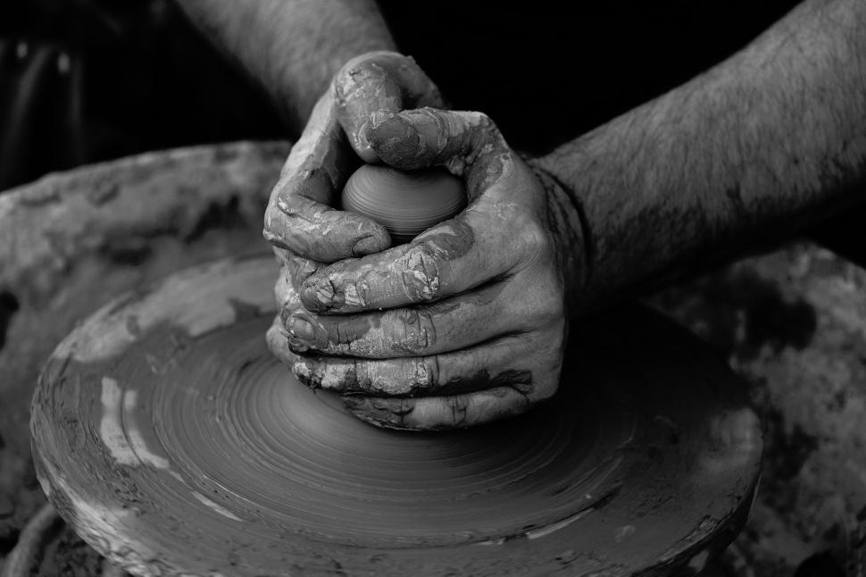 Free Image of Hands shaping clay on a pottery wheel symbolizing creation. 