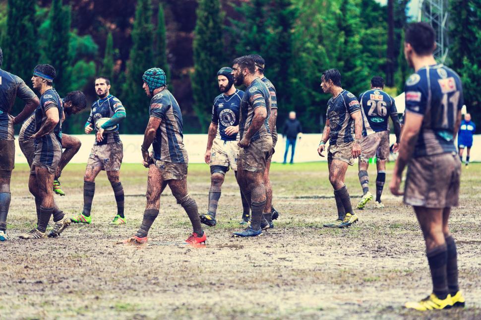 Free Image of Rugby team in action on a muddy field during a match 
