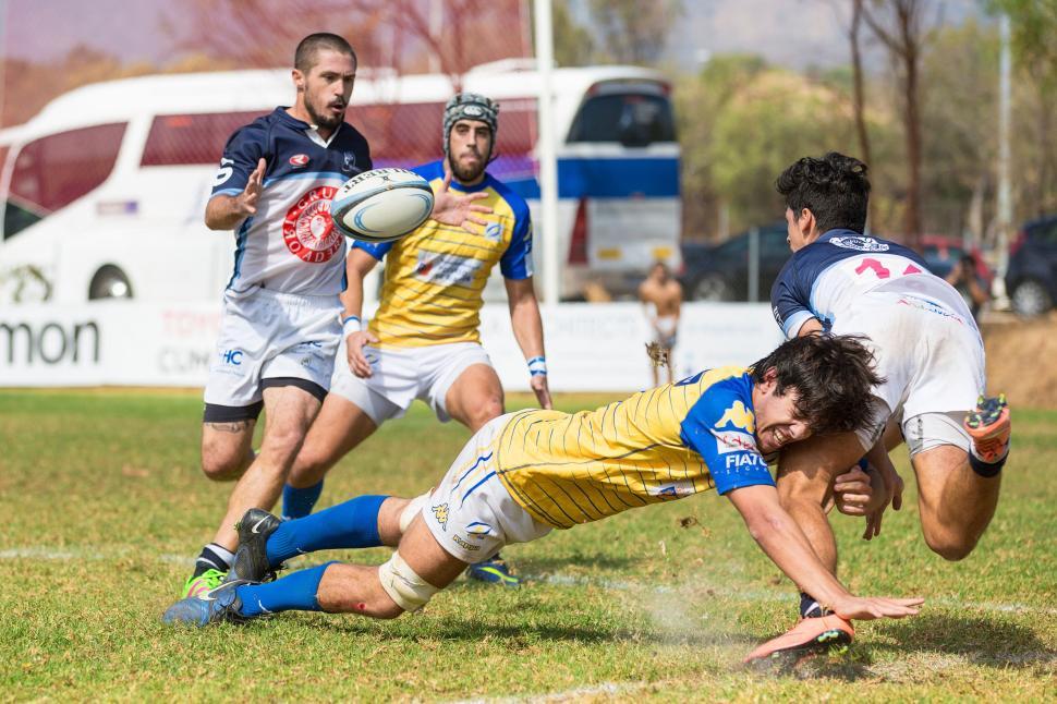 Free Image of Rugby player diving forward during competitive game 