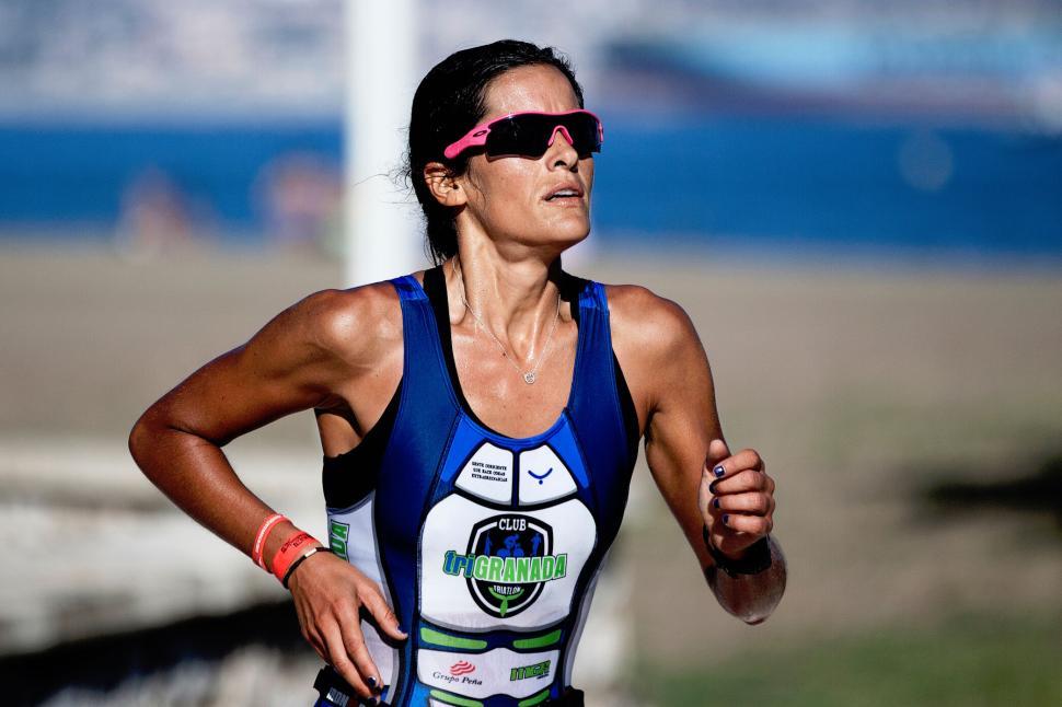 Free Image of Female triathlete in action during a beachfront race 