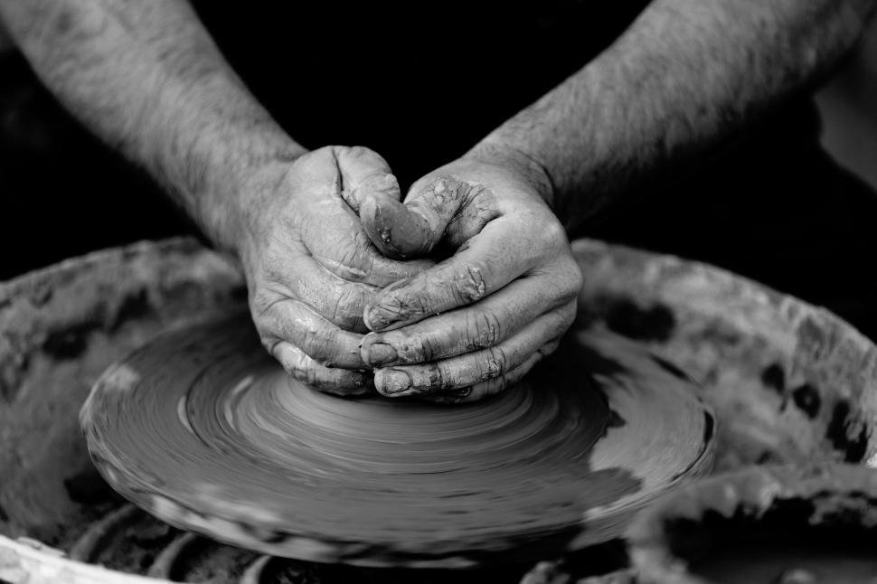 Free Image of Close-up of hands molding clay on a pottery wheel 