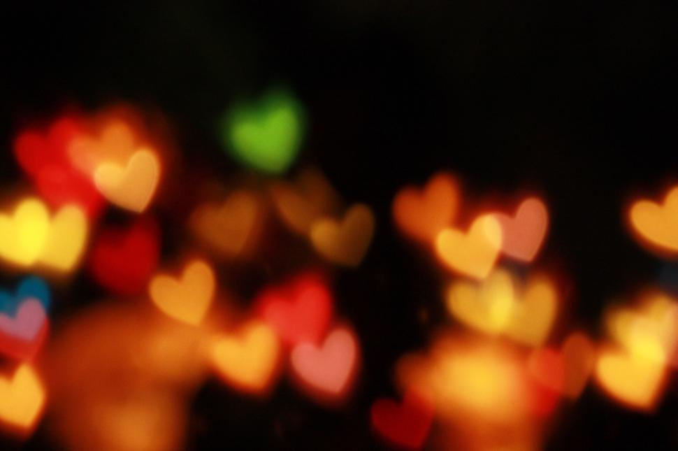 Free Image of Colorful heart bokeh lights in dark background image 
