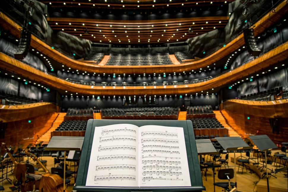 Free Image of Orchestra sheet music on stands in modern concert hall 