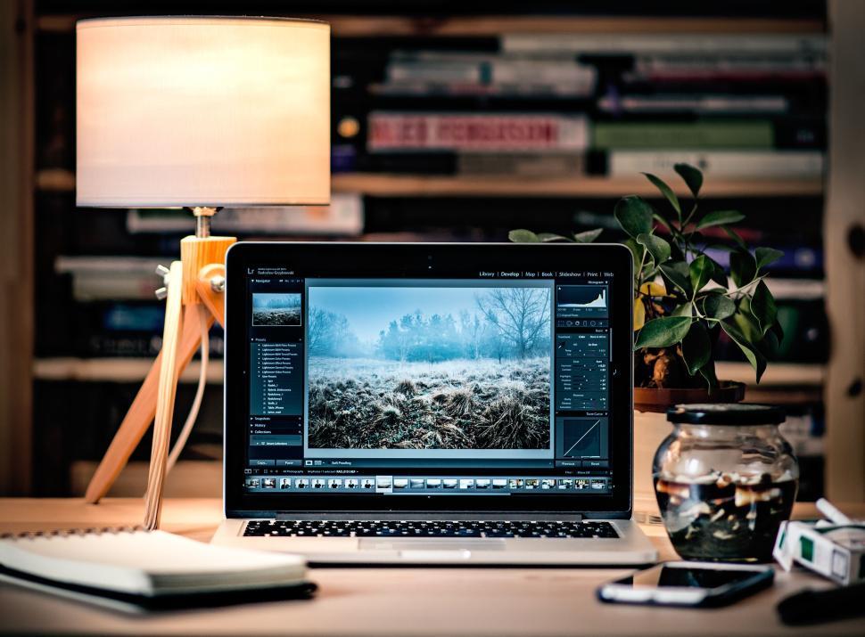Free Image of Laptop on desk setup for photo editing, creative workspace 