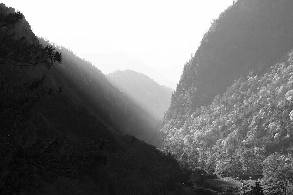 Free Image of Black and white photograph of mountain valley at dawn 