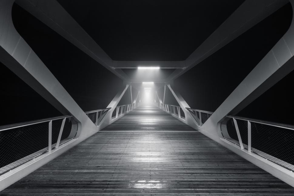 Free Image of Perspective shot of modern metal bridge walkway at night. 