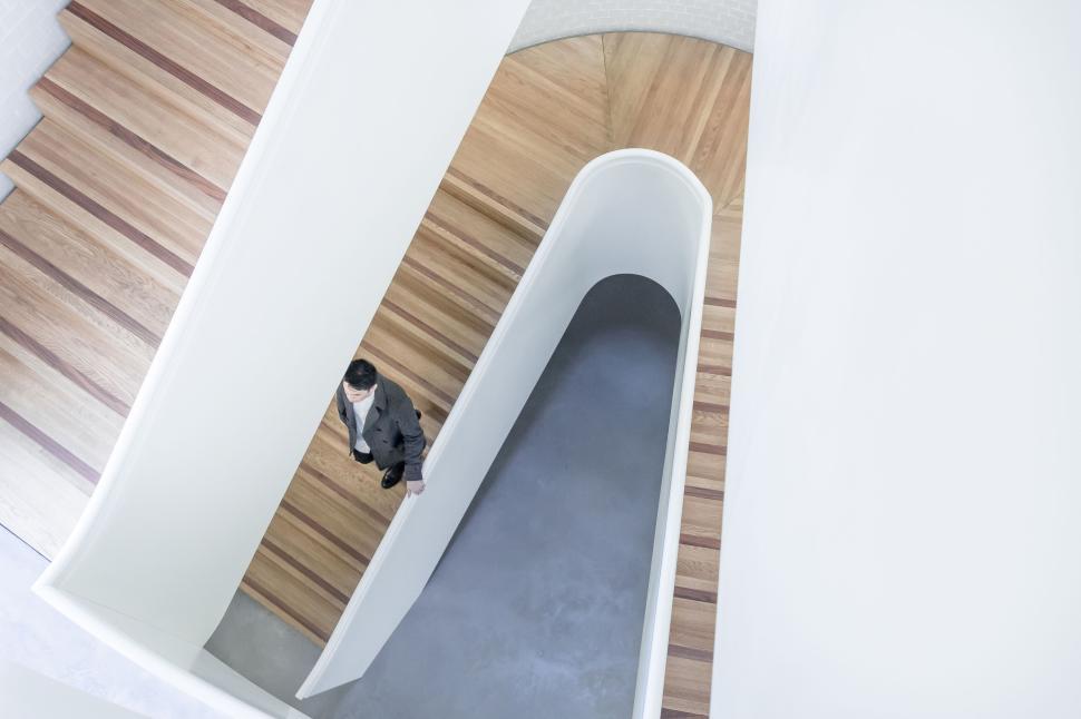 Free Image of Person ascending minimalist modern wooden staircase 