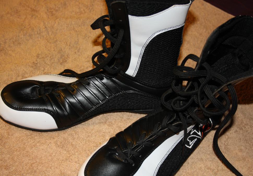 Free Image of Black and White Shoes Resting on Floor 