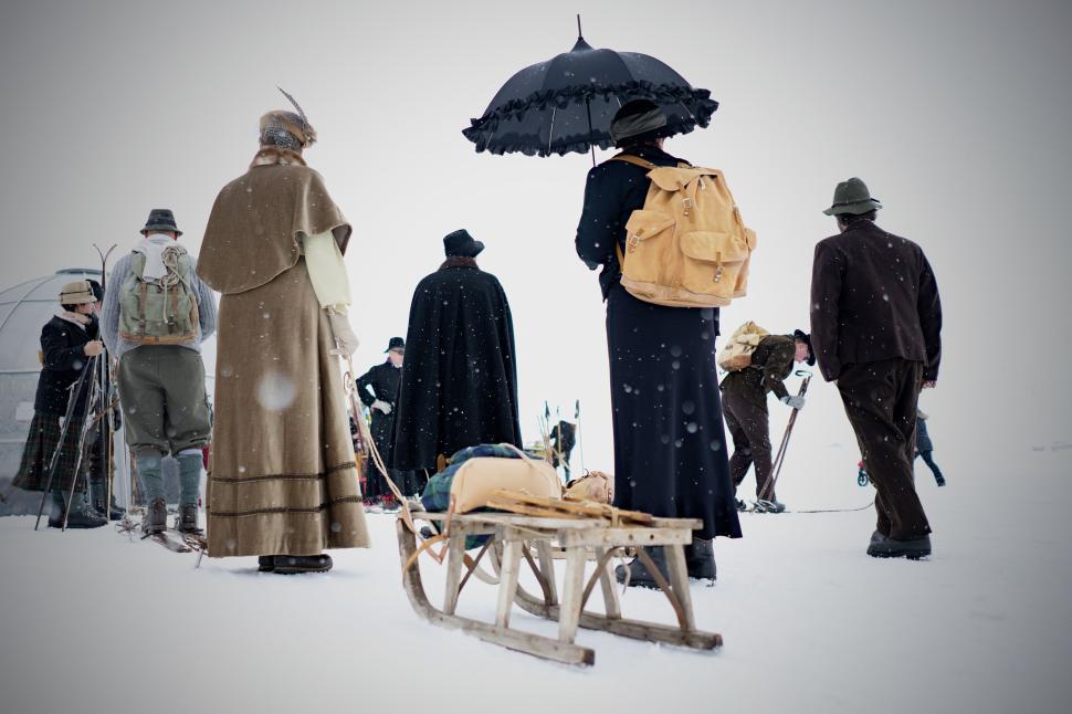 Free Image of People dressed in vintage clothing in snowy landscape. 