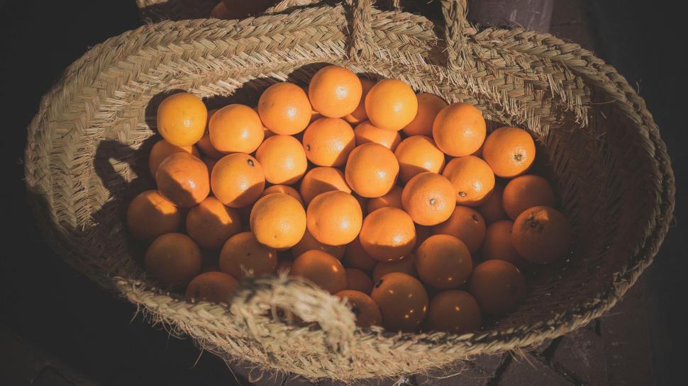 Free Image of Basket full of fresh oranges in natural light. 
