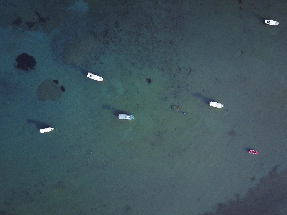 Free Image of Aerial view of small boats anchored on the calm waters. 