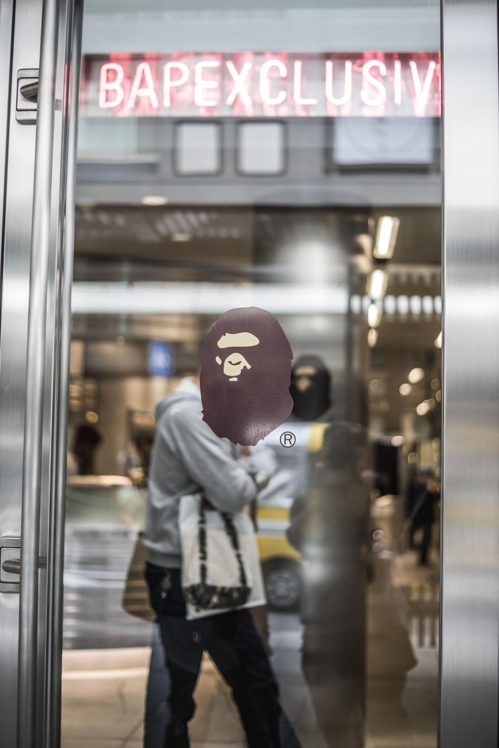 Free Image of Modern storefront entrance with reflective glass doors. 