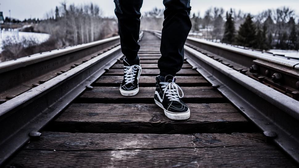 Free Image of Person walking on railway track in a solitary setting. 