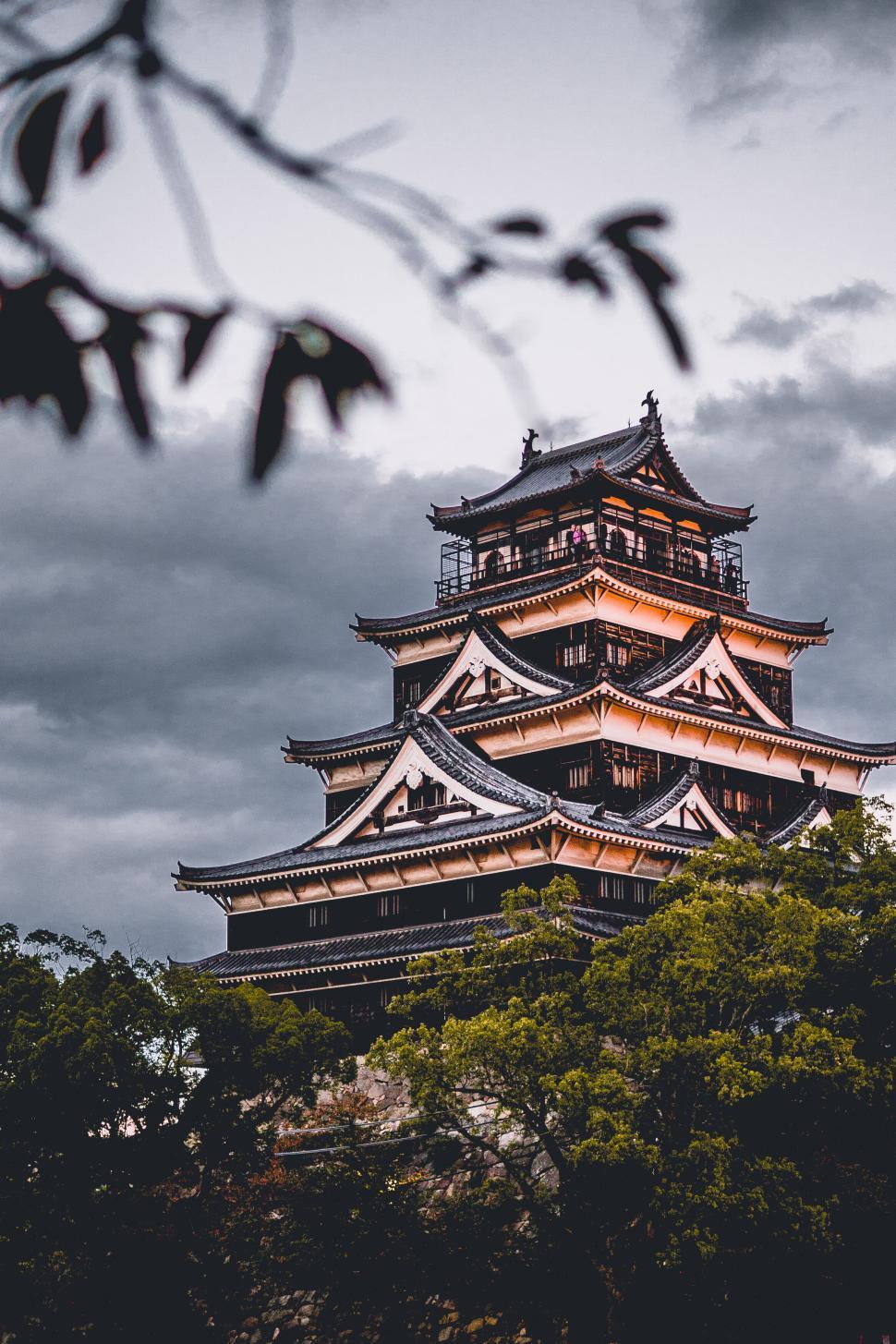 Free Image of Ancient Japanese castle tower against cloudy evening sky. 