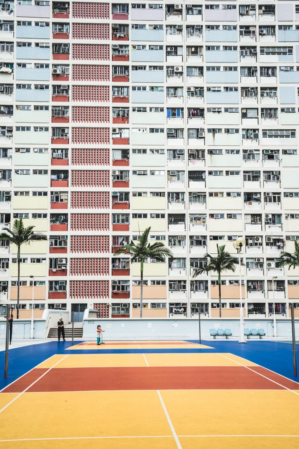 Free Image of Colorful residential building with a vibrant sports court 