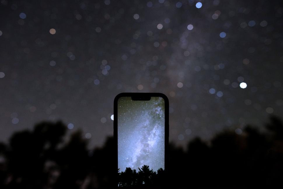 Free Image of Smartphone showing night sky with starry background. 