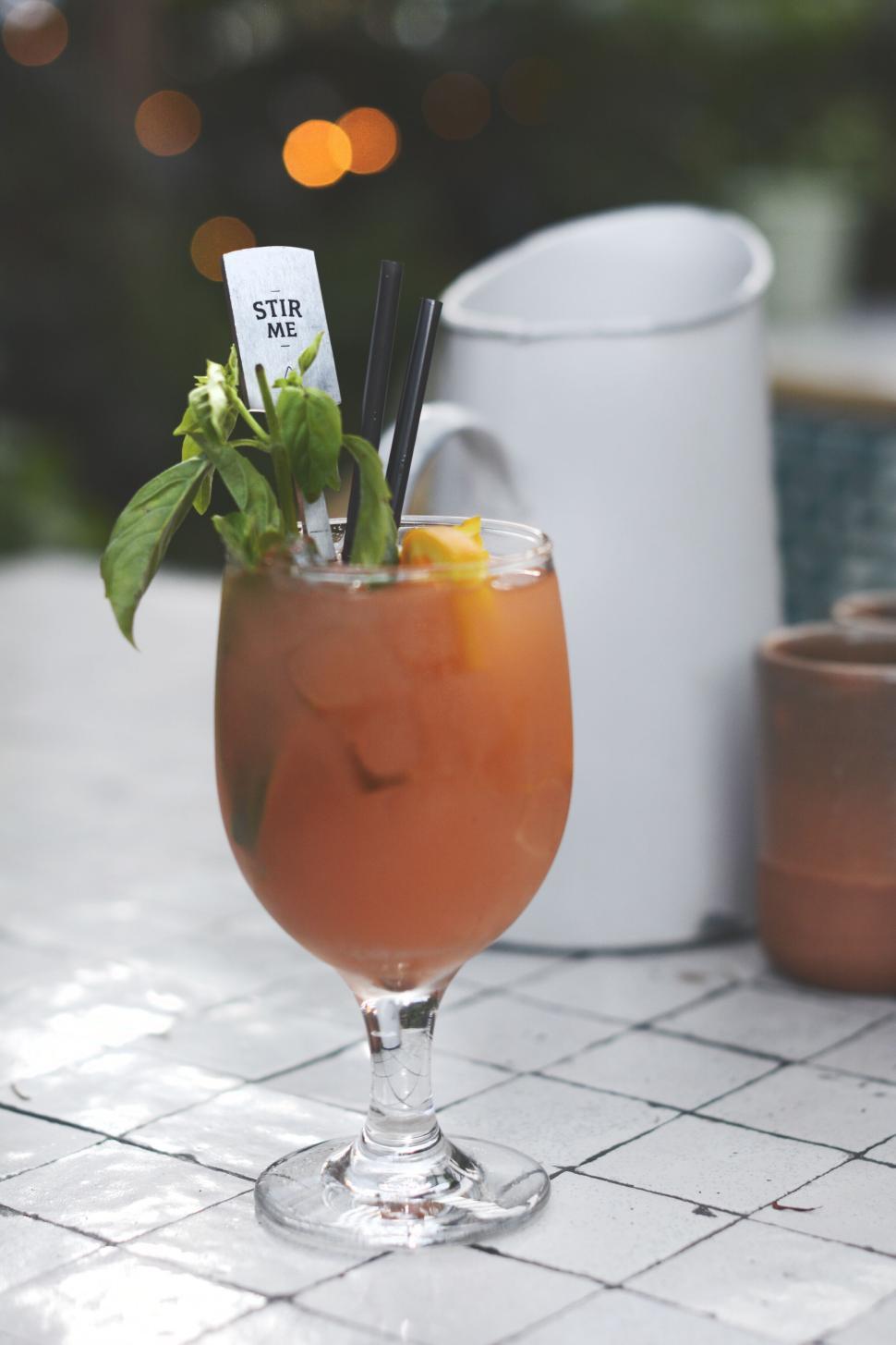 Free Image of Fancy cocktail with garnish on a white tiled table 