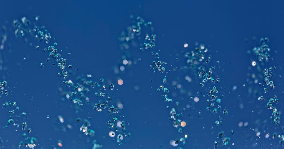 Free Image of Blurred water droplets against a deep blue background 
