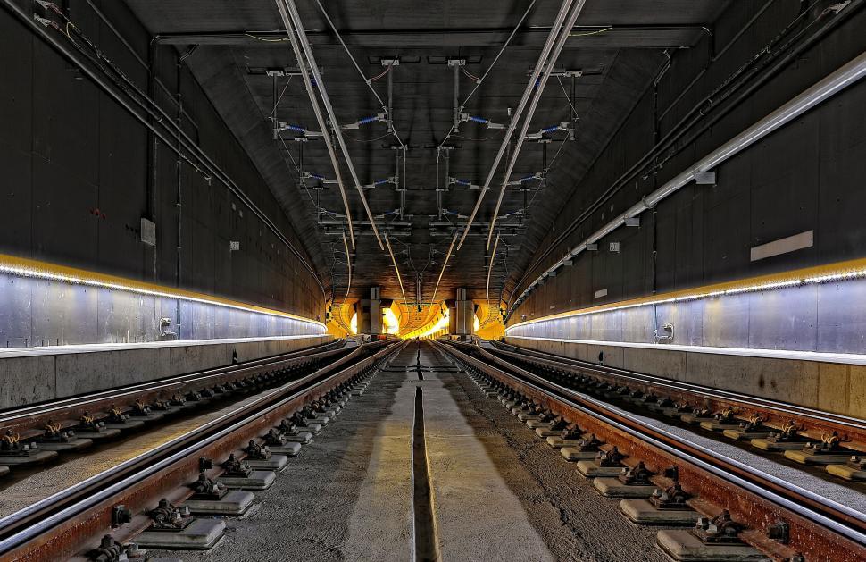 Free Image of Tunnel view of railway tracks leading to bright light 