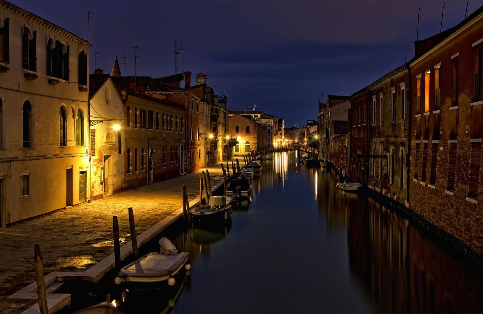 Free Image of Night scene of a calm canal lined with old buildings 