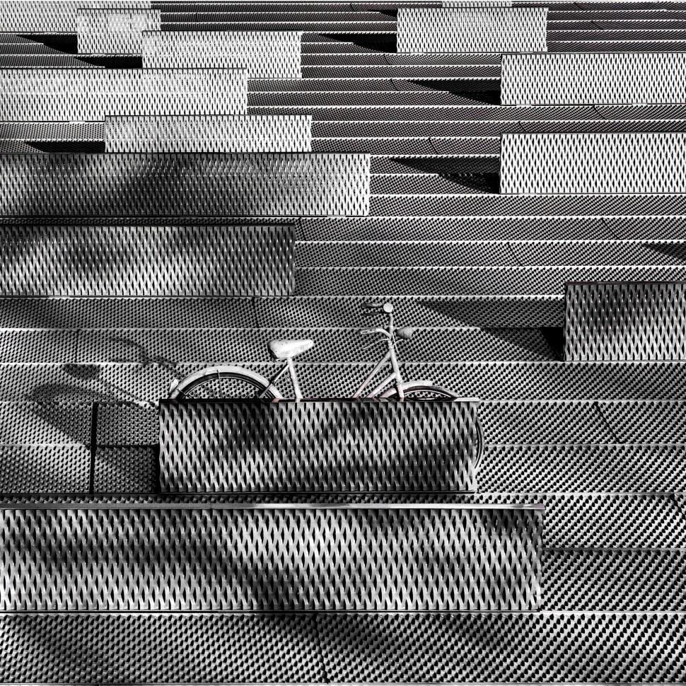 Free Image of Modern art installation with bicycle and metal bar pattern. 