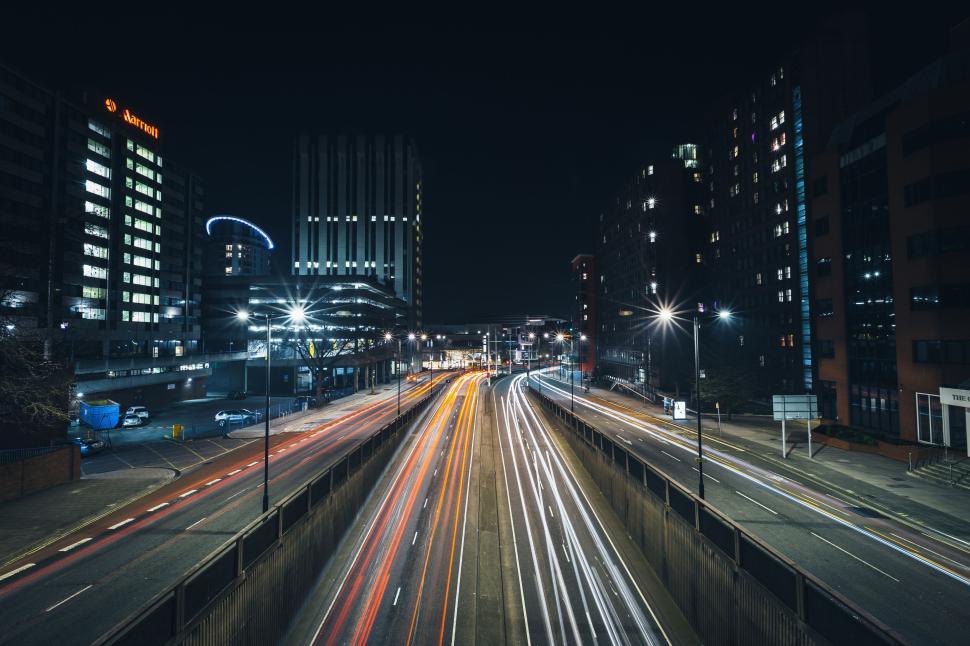 Free Image of Night cityscape with light trails on busy road 