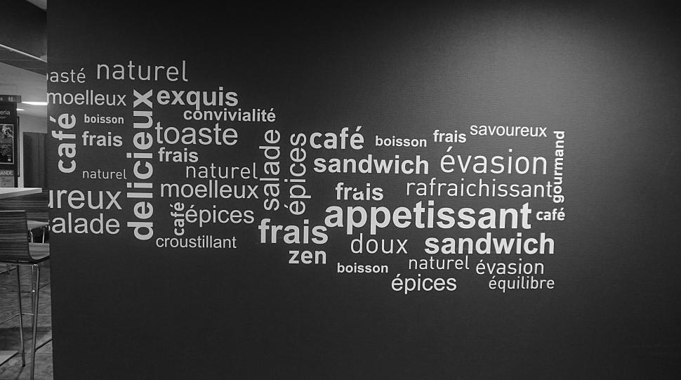 Free Image of Black and white word collage on a cafe wall decor. 