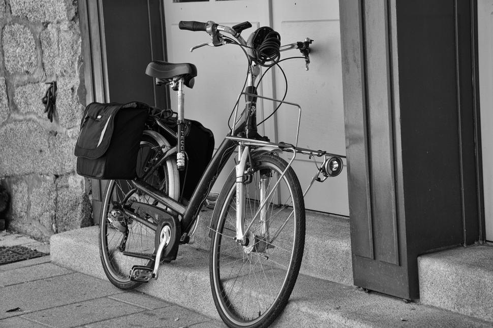 Free Image of Bicycle resting on steps with bag on rear rack 