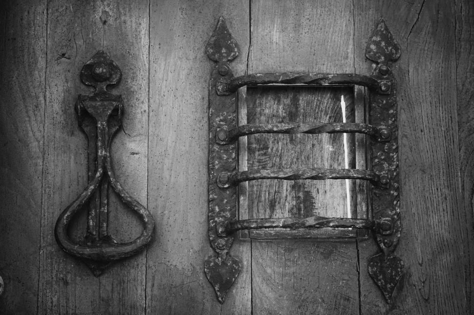 Free Image of Vintage iron handle and latch on old wooden door surface. 