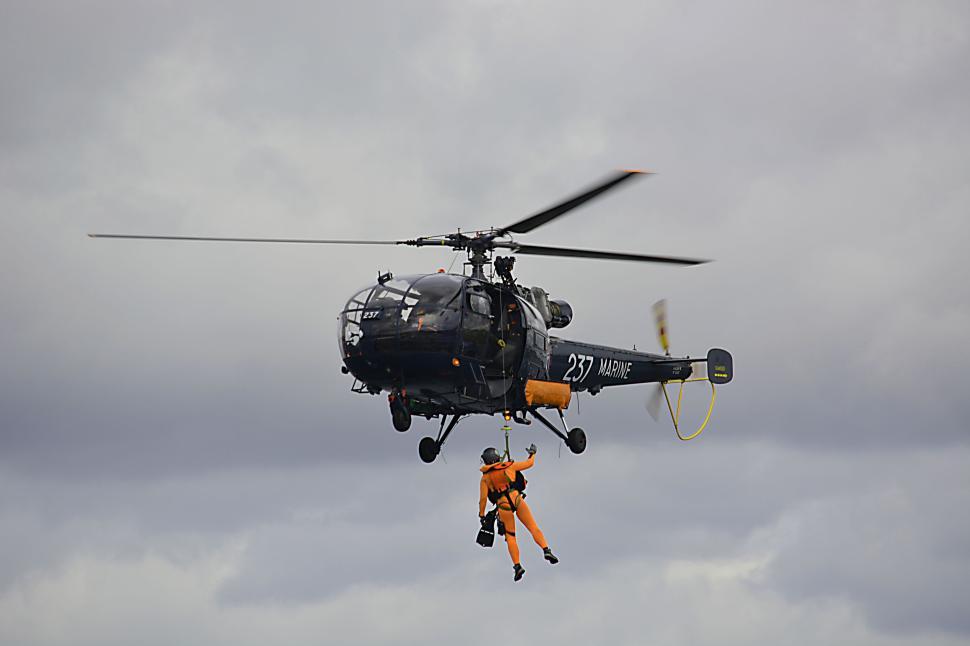 Free Image of Marine rescue operation with helicopter and person. 