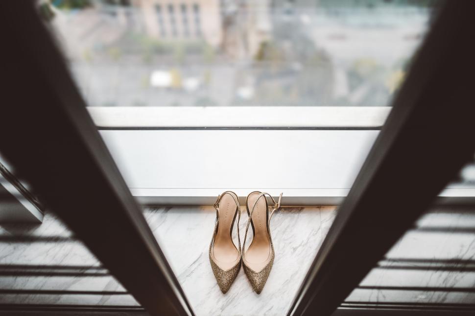 Free Image of Elegant high heels standing on a marble floor near window 
