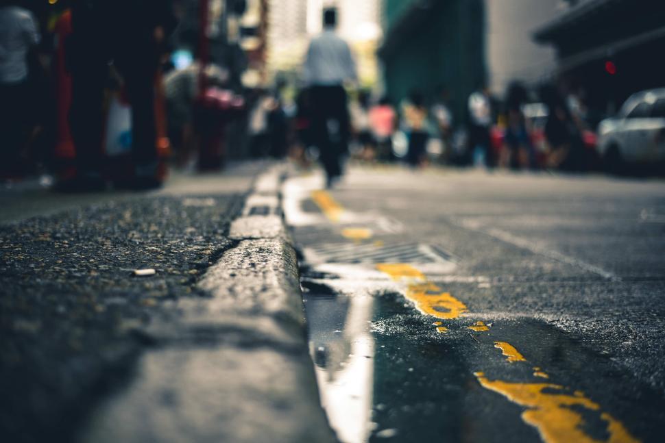 Free Image of City street with blurred motion of people and vehicles. 