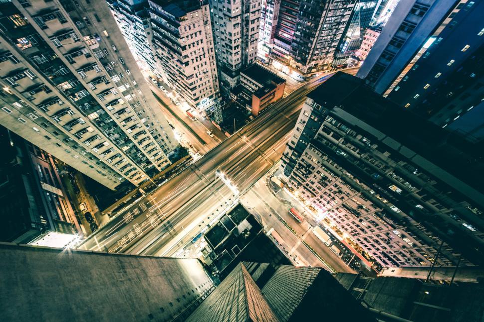Free Image of Tilted aerial view of illuminated city buildings at night 