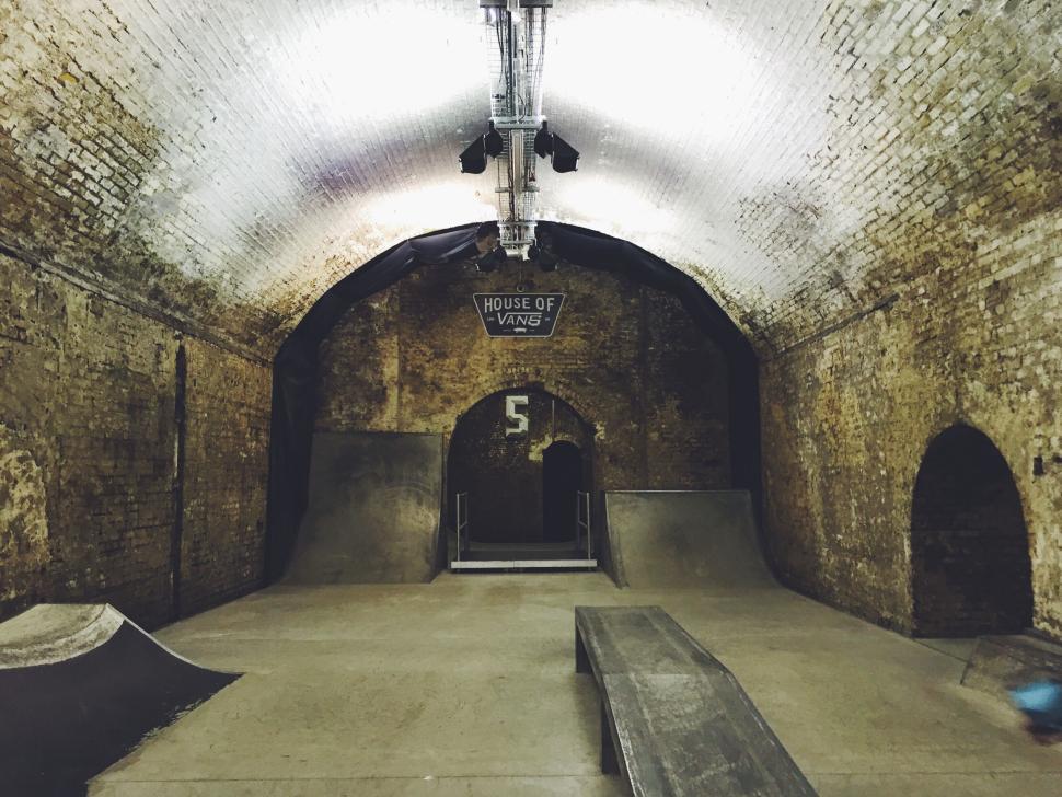 Free Image of Underground skatepark with ramps and brick walls. 