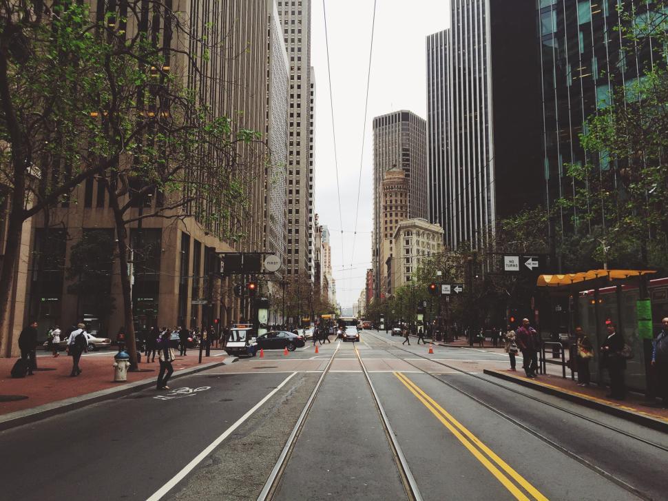 Free Image of Bustling city street lined with modern skyscrapers. 