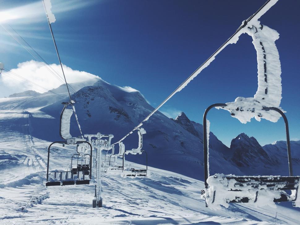 Free Image of Ski lift in snowy mountains under clear blue sky 