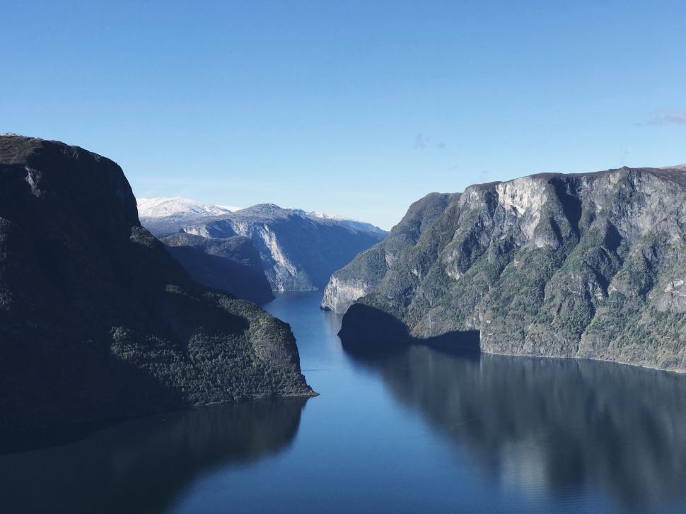 Free Image of Serene fjord landscape with blue water and steep cliffs 
