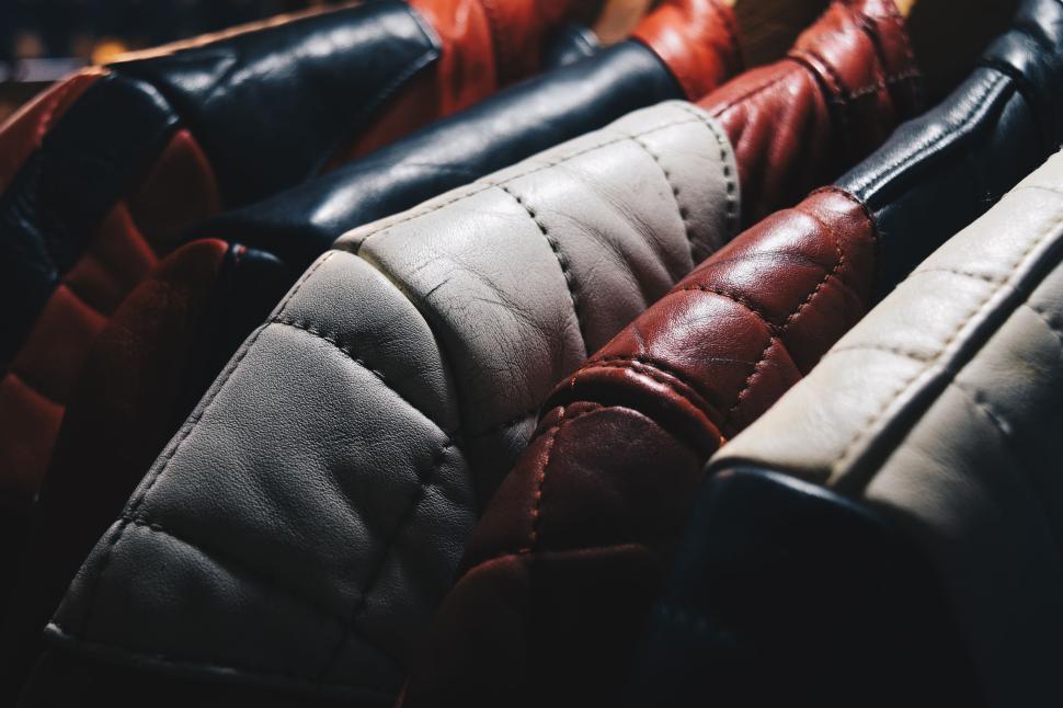Free Image of Row of colorful leather jackets hanging closely together. 