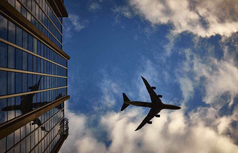 Free Image of Silhouette of an airplane against a bright sky 