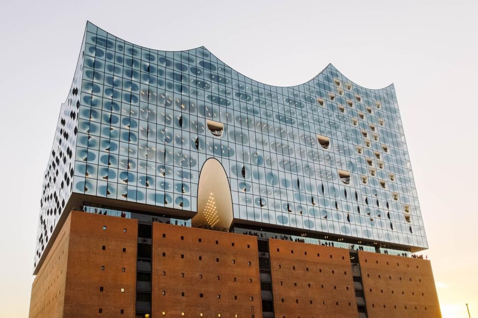 Free Image of Modern Glass Building with Wavy Architecture in Evening 
