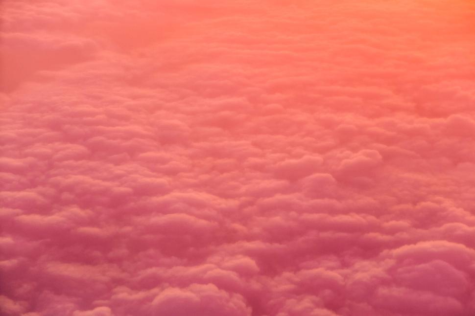 Free Image of Vast Sea of Pink and Orange Fluffy Clouds at Sunset Time 