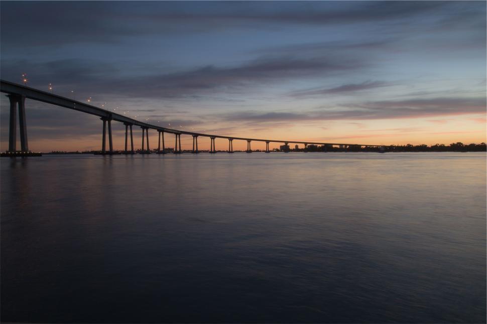 Free Image of Bridge over calm water during twilight hour 