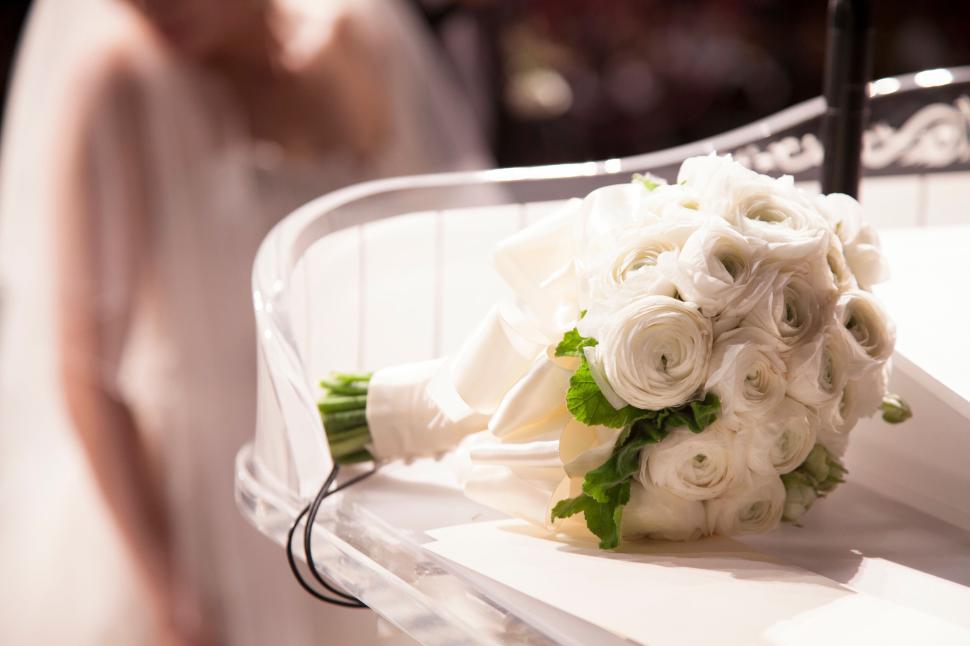 Free Image of Close-up of a white wedding bouquet on a white fabric. 