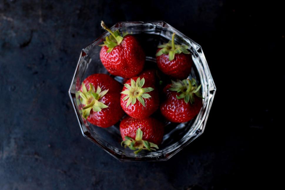 Free Image of Fresh strawberries in a crystal bowl on a dark surface 
