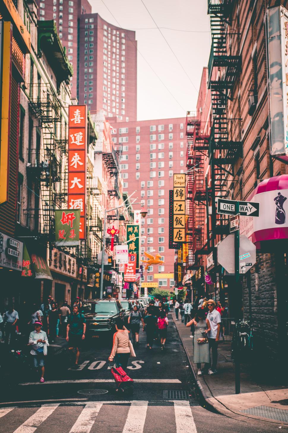 Free Image of Bustling city street scene lined with various shops 