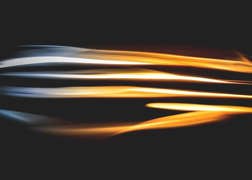 Free Image of Abstract light streaks in various shades of yellow and white 