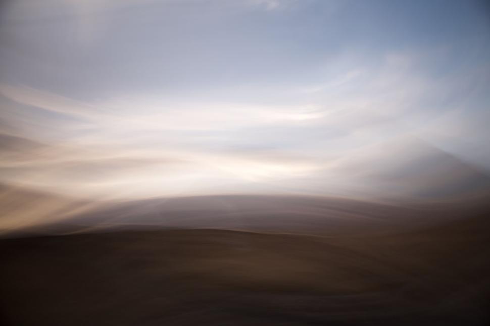 Free Image of Abstract blurry landscape with blue and brown hues 